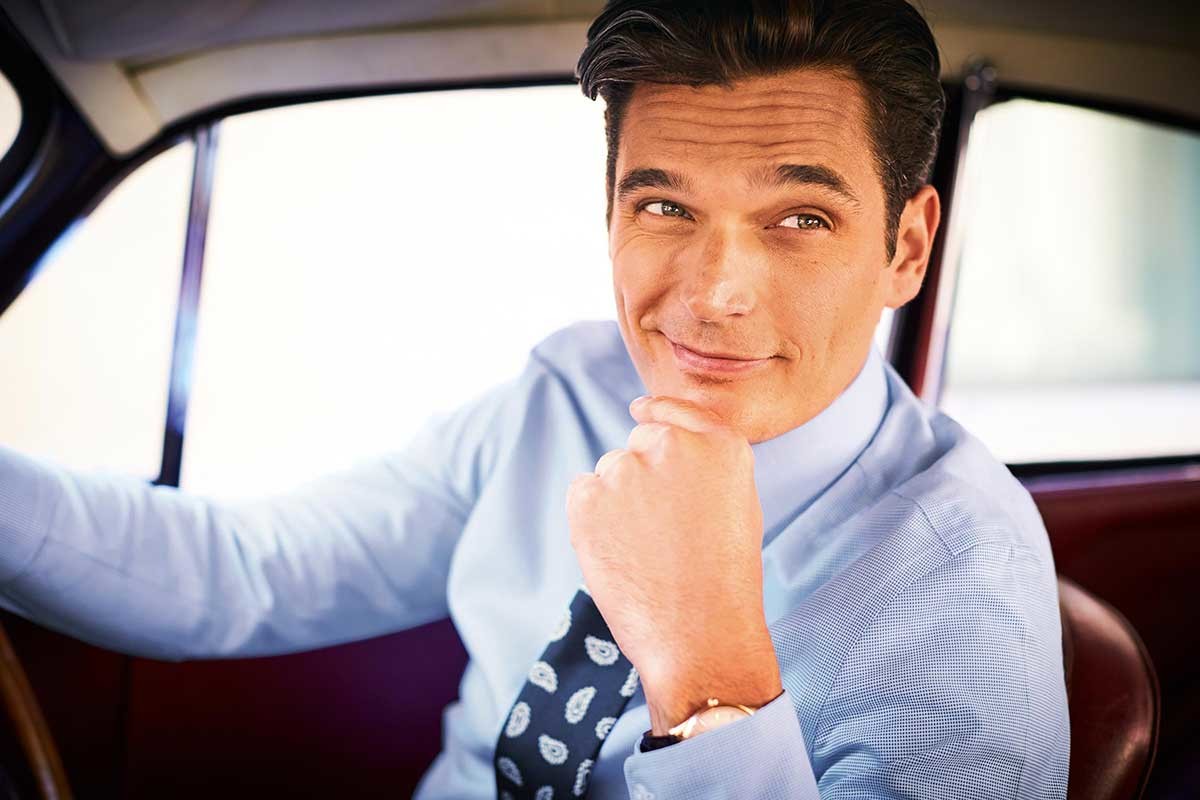 model wearing a non iron shirt with a blue tie